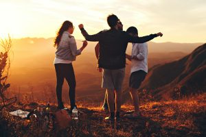 Wise Options For a Good and Happy Life By Tomer Levi  Four Person Standing at Top of Grassy Mountain