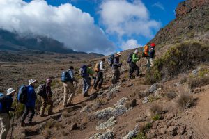 people hiking on/ Itai Liptz about mountain climbing mountain during daytime