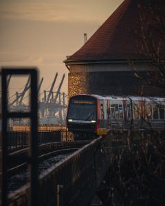 Red and Blue Train on Rail Tracks  By Tomer Levi Forex